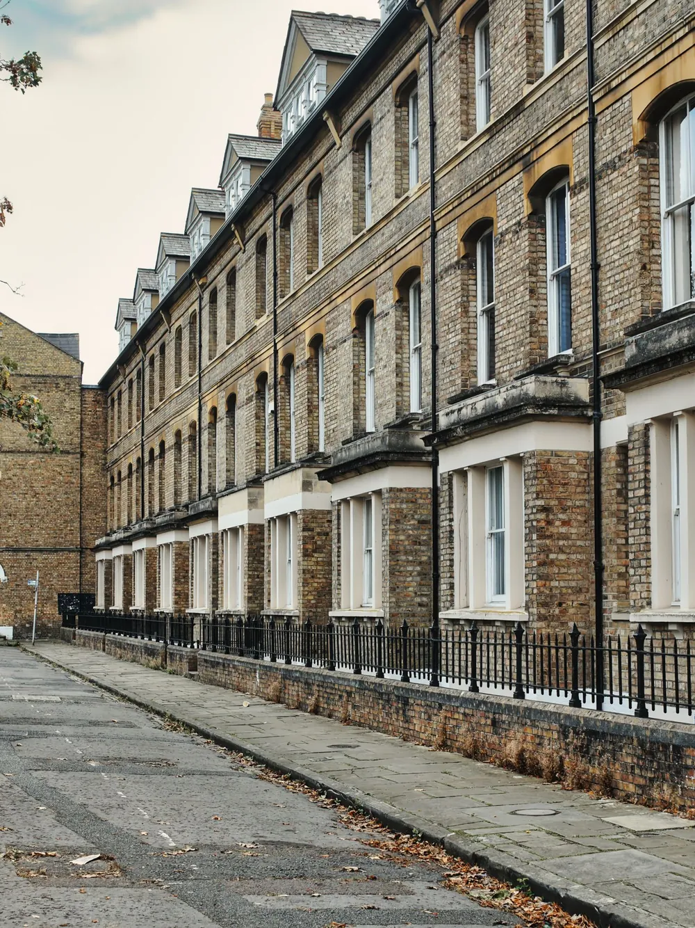 A quiet street of Victorian terraced houses in brick